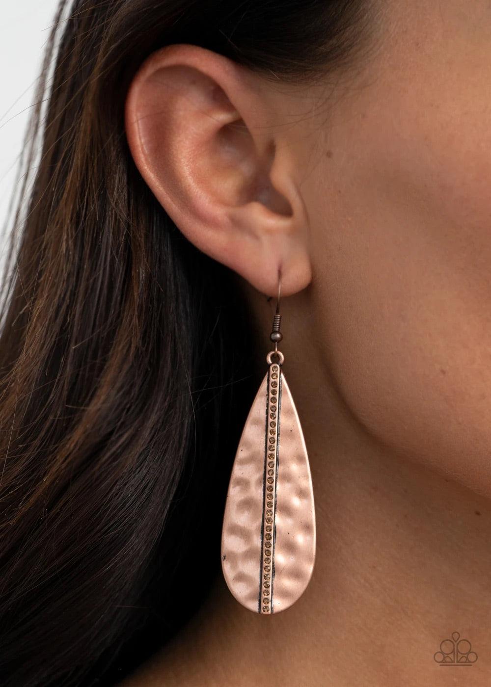 Paparazzi Accessories On The Up and UPSCALE - Copper A single row of dainty topaz rhinestones is vertically embossed down the center of a hammered copper teardrop, adding an unexpected splash of refinement to the classic frame. Earring attaches to a stand