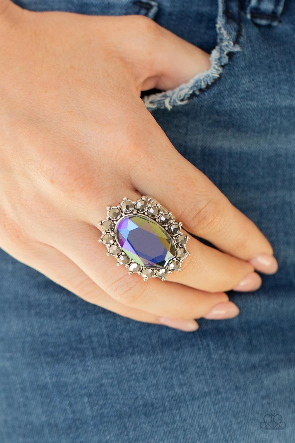 Paparazzi Accessories Bling of All Bling - Multi Hematite rhinestone encrusted petals bloom from an oversized iridescent blue gem, creating a dramatic centerpiece atop the finger. Features a stretchy band for a flexible fit. Sold as one individual ring. J