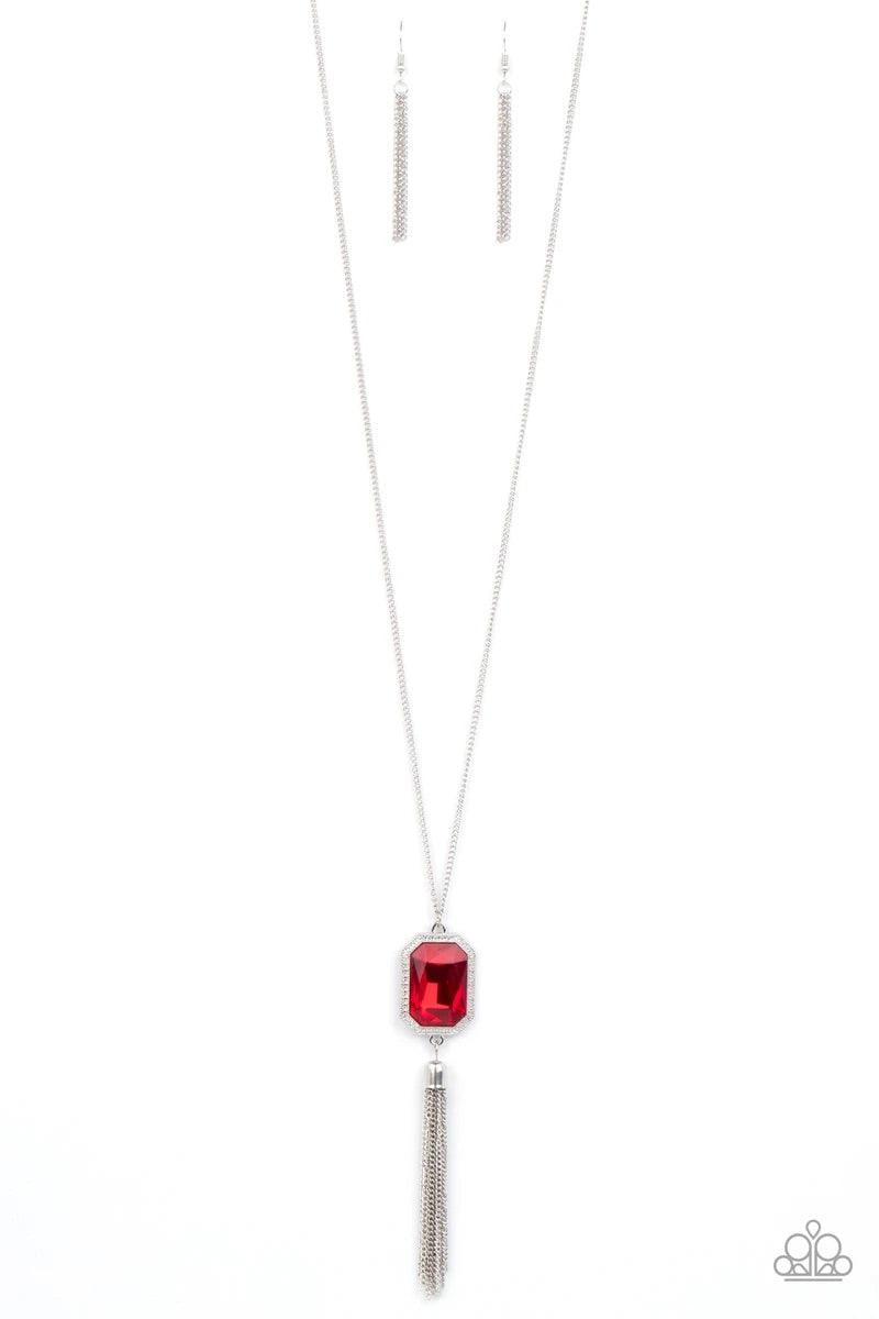 Paparazzi Accessories Blissed Out Opulence - Red An impressive red emerald cut gem is pressed into the center of a silver studded frame, creating an ethereal pop of color at the bottom of a lengthened silver chain. A silver chain tassel swings from the bo