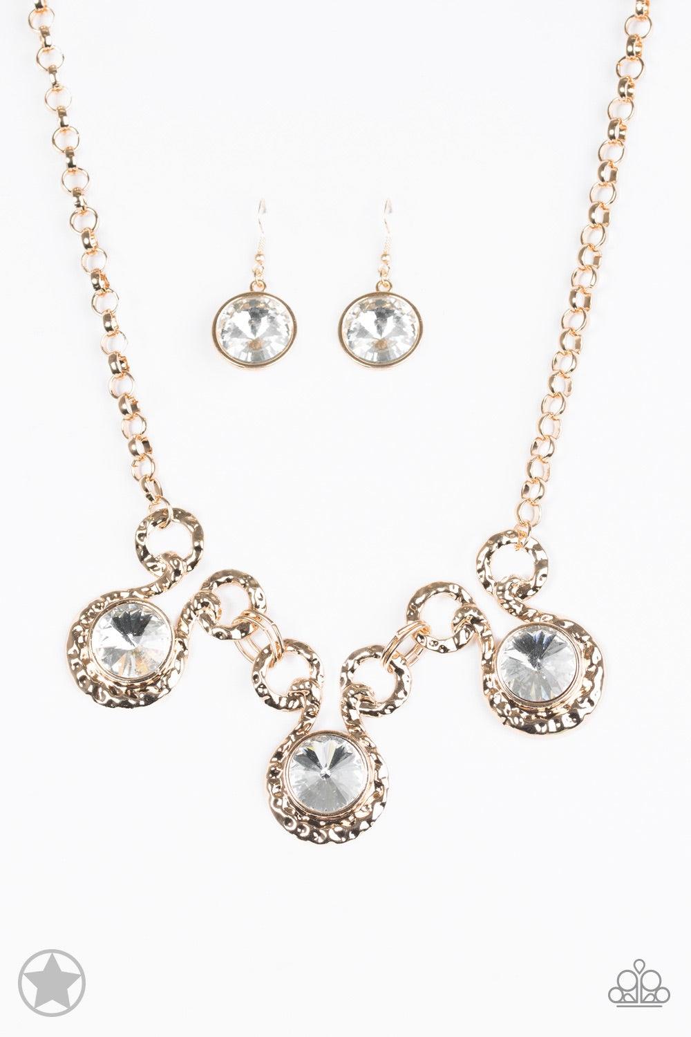 Paparazzi Accessories Hypnotized - Gold Three dramatically oversized rhinestones are nestled into three textured gold fittings that are connected by oval gold rings, creating a brilliant statement piece. Features an adjustable clasp closure. Jewelry