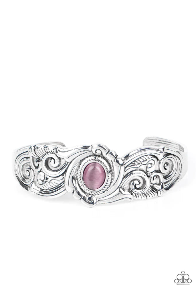 Paparazzi Accessories Glowing Enchantment - Purple Embossed in vine-like filigree patterns, an ornately scalloped silver cuff is adorned with a glassy purple cat's eye center for an ethereal finish. Sold as one individual bracelet. Bracelets
