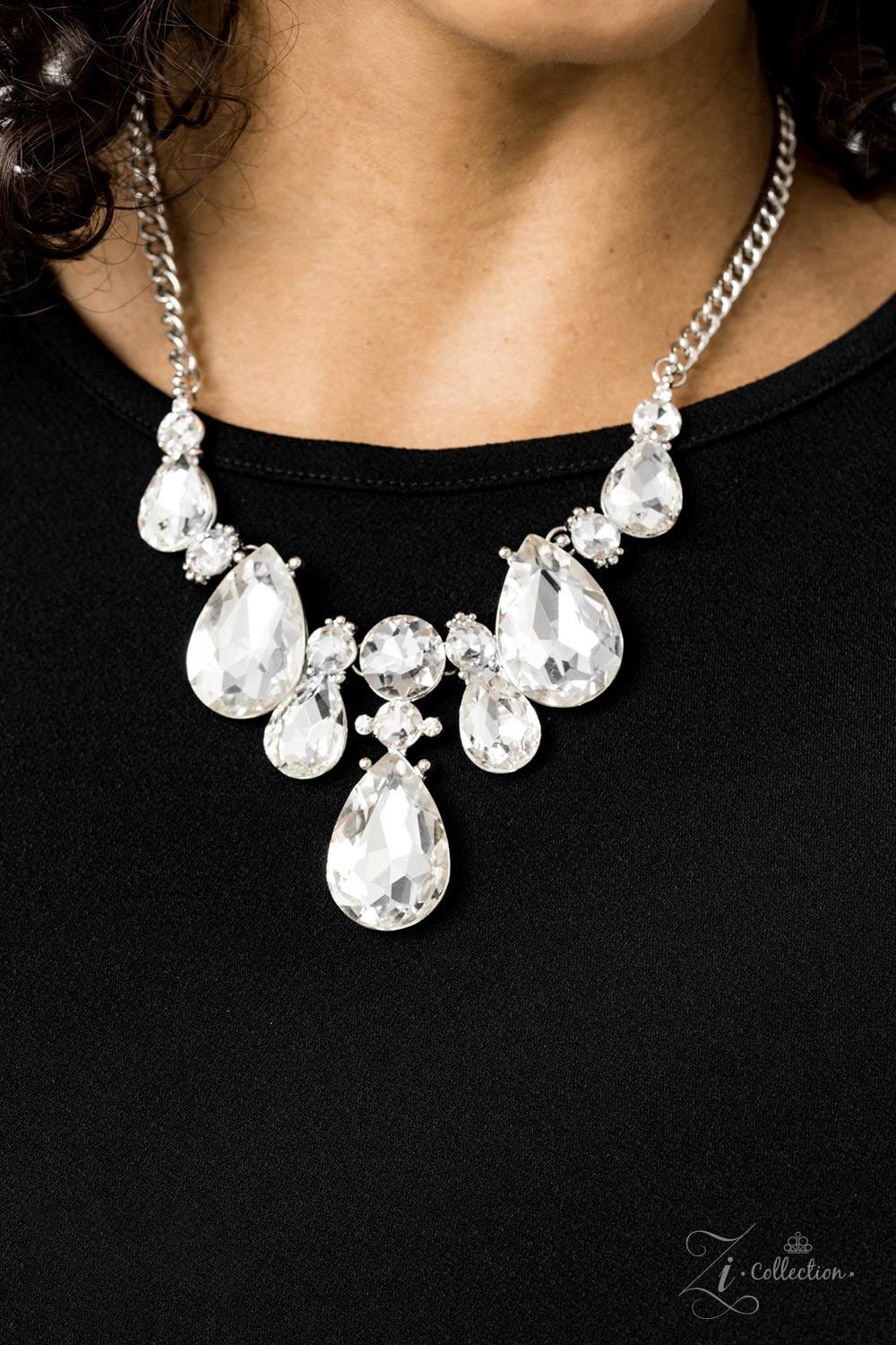Paparazzi Accessories Reign Dramatic frames featuring tranquil teardrop and classic round white rhinestones delicately link below the collar for a showstopping look. A large teardrop rhinestone drips from the center, creating an unapologetic pendant that