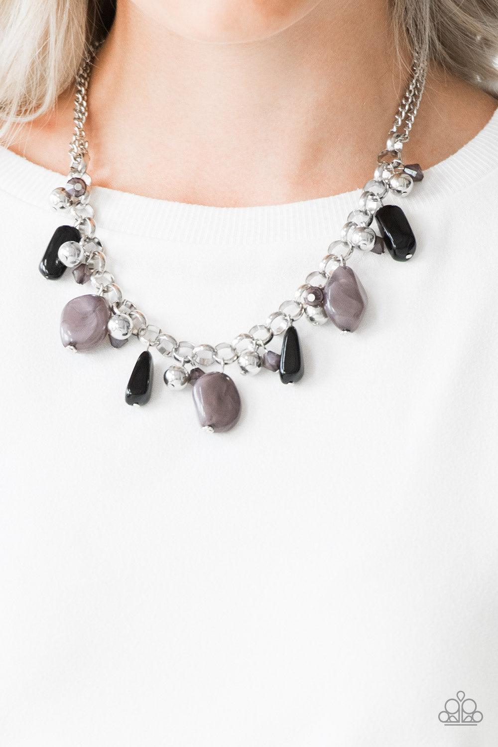 Paparazzi Accessories Grand Canyon Grotto - Black Featuring polished and cloudy finishes, a collection of black faux rocks dance from the bottom of a bold silver chain. Classic silver beads trickle between the colorful beading, adding a metallic shimmer t