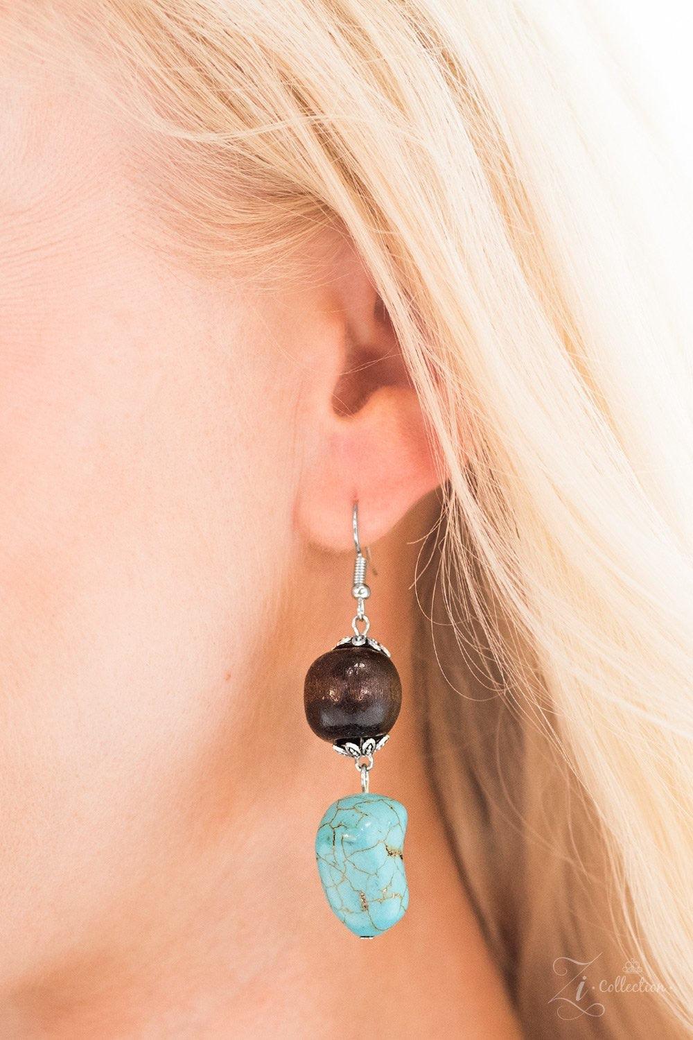 Paparazzi Accessories Groundbreaker Featuring imperfect finishes, refreshing turquoise stones trickle along three shimmery silver chains. Earthy wooden accents are added to the tranquil layers for a natural, artisanal inspired look. Features an adjustable