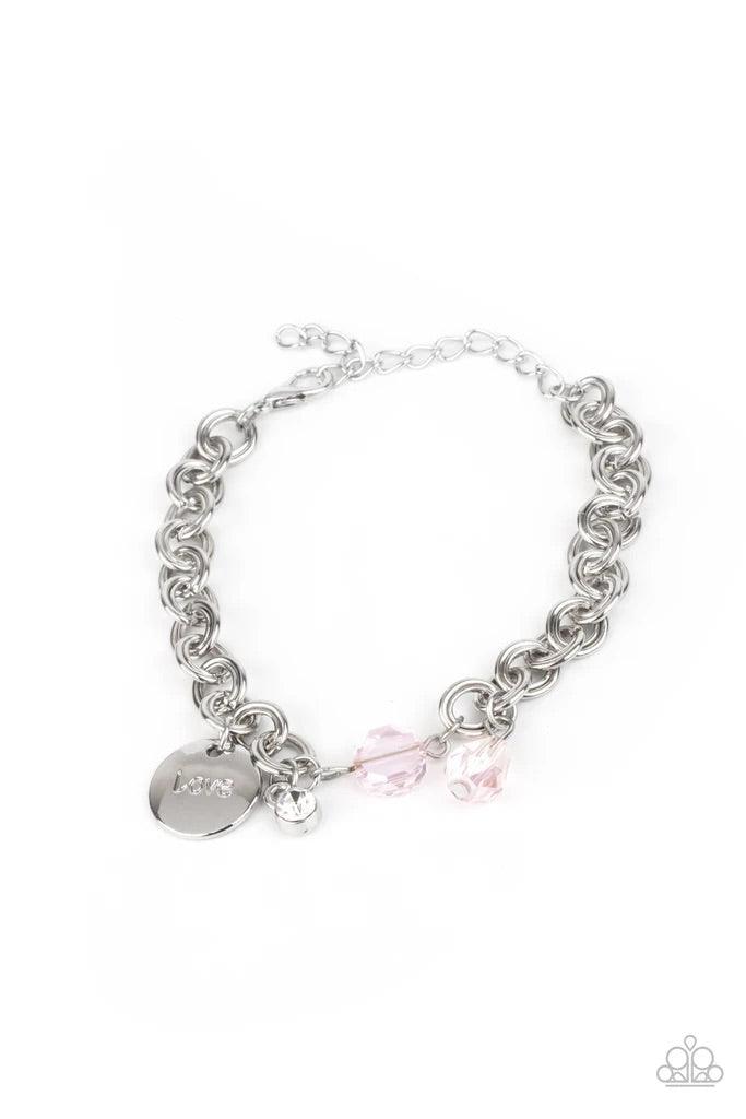 Paparazzi Accessories Lovable Luster - Pink Pink crystal-like beads, a dainty white rhinestone, and a silver disc stamped in the word, "love," adorn a double-linked silver chain, creating a flirty fringe around the wrist. Features an adjustable clasp clos