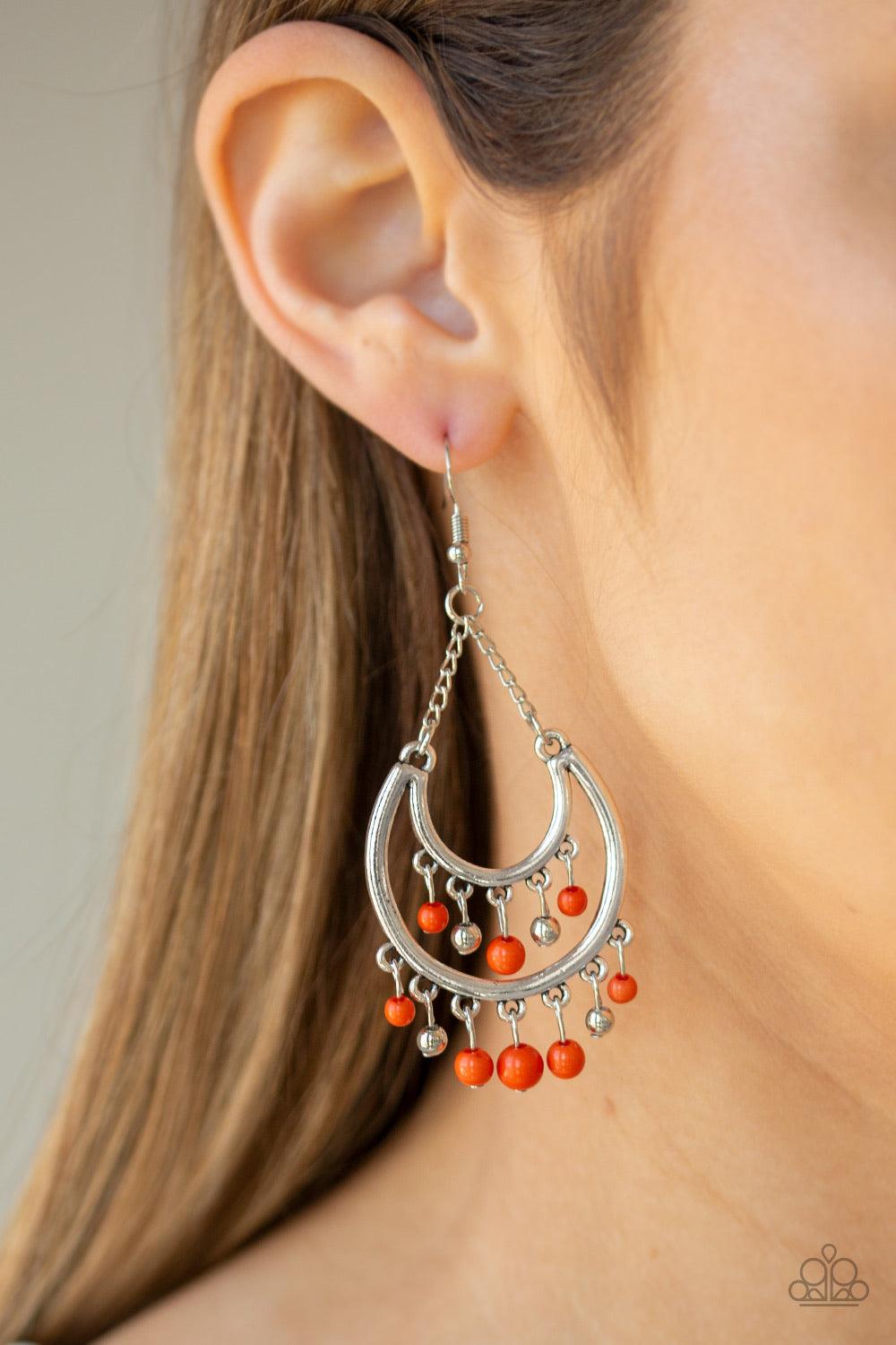 Paparazzi Accessories Free-Spirited Spirit - Orange Dainty orange and silver beads swing from the top and bottom of a shimmery silver half-moon frame, creating a vivacious fringe. Earring attaches to a standard fishhook fitting. Jewelry