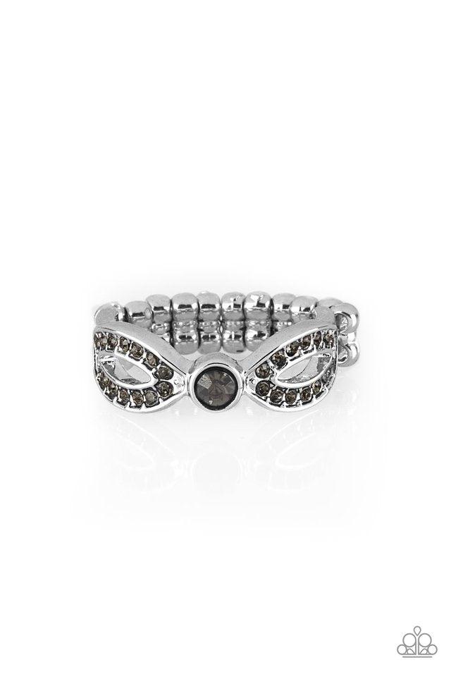 Paparazzi Accessories Extra Side of Elegance - Silver Encrusted in smoky rhinestones, glistening silver ribbons loop away from a dazzling rhinestone center for a refined look. Features a dainty stretchy band for a flexible fit. Sold as one individual ring