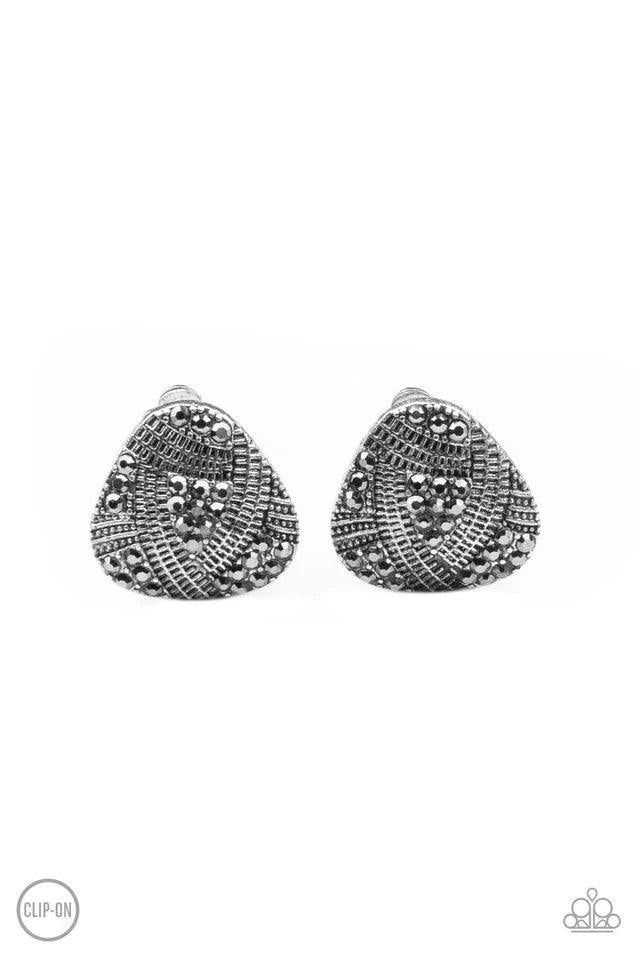 Paparazzi Accessories Gorgeously Galleria - Silver *Clip-On Studded and textured ribbons of silver wrap around sections of smoky hematite rhinestones, creating an edgy display. Earring attaches to a standard clip-on fitting. Sold as one pair of clip-on ea