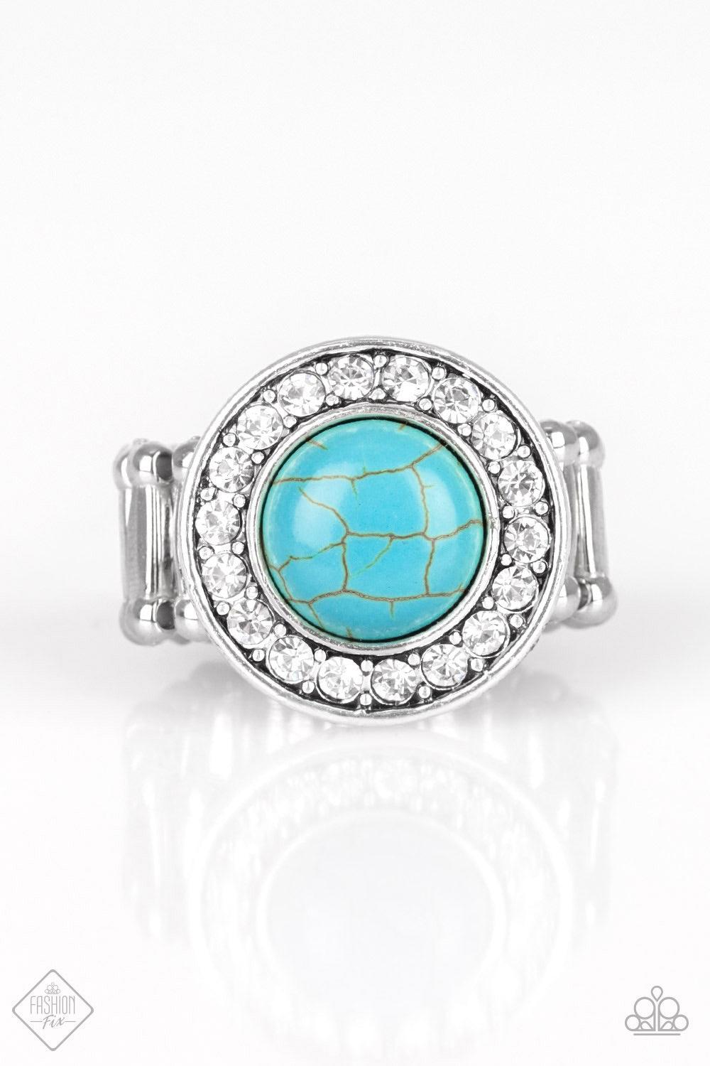 Paparazzi Accessories Rugged Radiance - Blue A refreshing turquoise stone is pressed into the center of a round silver frame radiating with glassy white rhinestones, creating an earthy, yet refined design. Features a stretchy band for a flexible fit. Jewe
