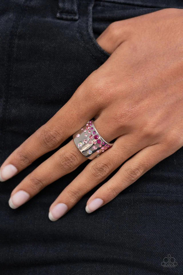 Paparazzi Accessories Sizzling Sultry - Pink Featuring iridescent and glassy finishes, glitzy rows of pink and multicolored rhinestones are haphazardly sprinkled across the front of a thick silver band for a colorful splash of ombre sparkle. Features a st