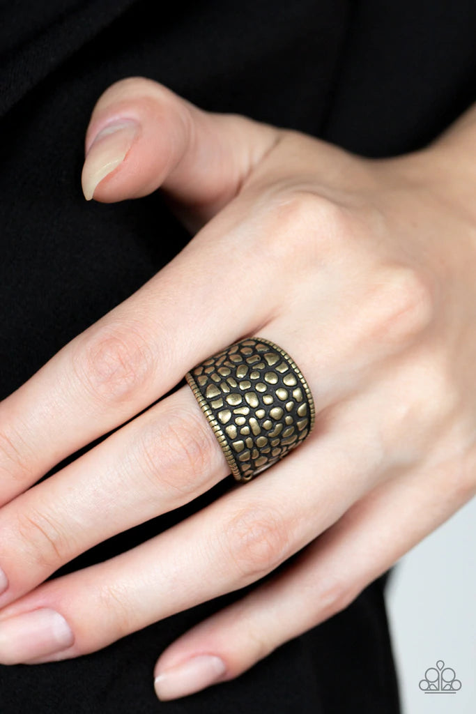 Paparazzi Accessories Dotted Decorum - Brass Brimming from edge to edge with a studded texture reminiscent of cobblestone, a wide brass band is bordered in dainty studs resulting in a free-spirited fashion atop the finger. Features a stretchy band for a f