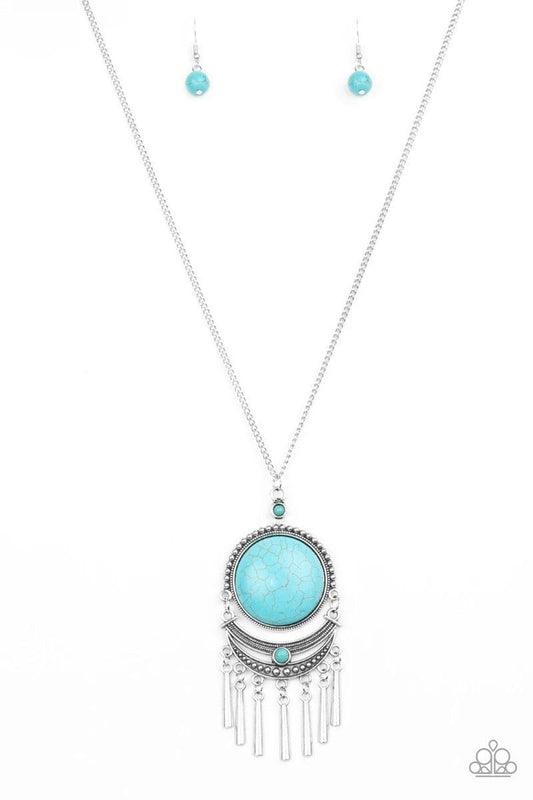 Paparazzi Accessories Rural Rustler - Blue Swinging from the bottom of a lengthened silver chain, a dramatic turquoise stone gives way to an ornate crescent shaped frame dotted with a dainty turquoise stone. Brushed in an antiqued shimmer, flared silver b