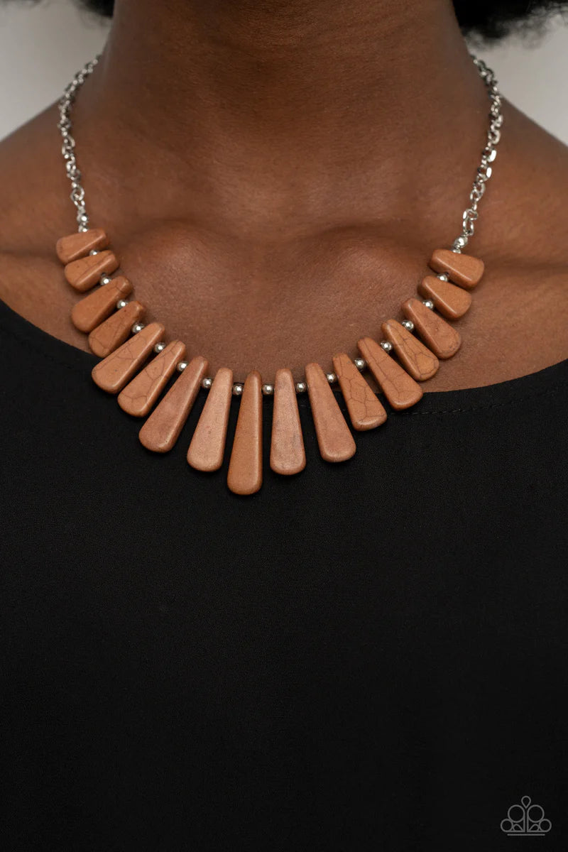 Paparazzi Accessories Mojave Empress - Brown Separated by dainty silver beads, pieces of triangular cut brown stones gradually increase in size as they fan out below the collar for an earthy statement. Features an adjustable clasp closure. Sold as one ind