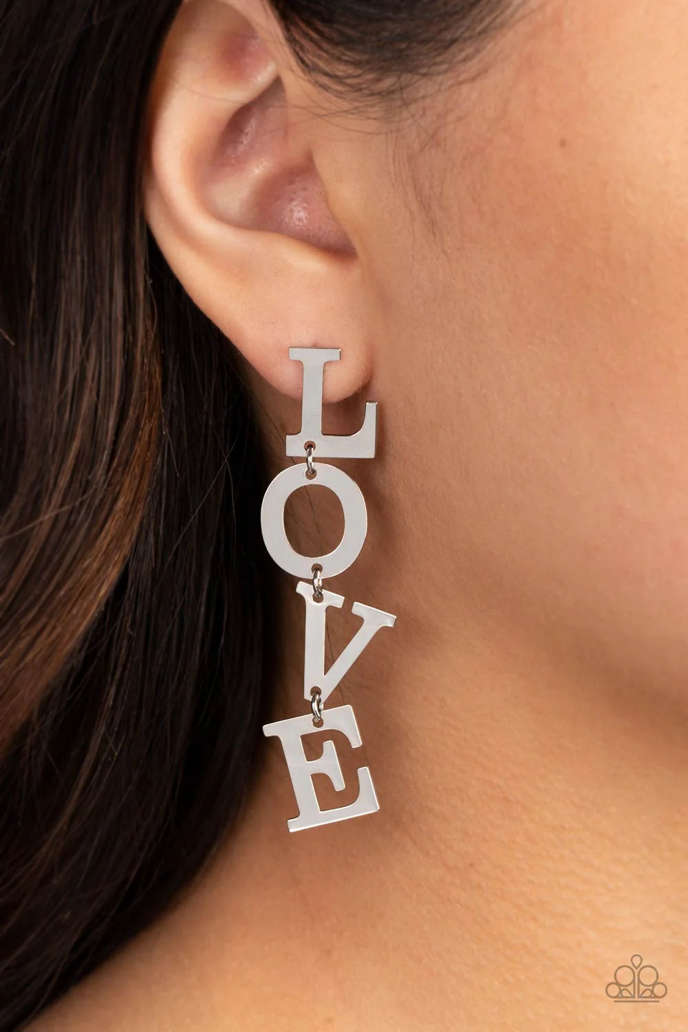Paparazzi Accessories L-O-V-E - Silver Silver letters with a lightly hammered sheen spell out the word "LOVE" as they vertically cascade down the ear in a flattering finish. Each of the letters are interconnected to one another giving the piece some whims