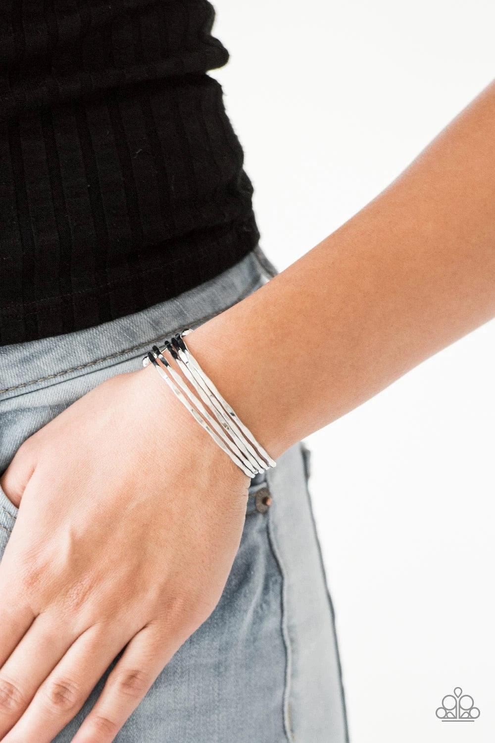 Paparazzi Accessories Street Refinement ~Silver Delicately hammered in sections of shimmer, glistening silver bars are threaded along two metallic rods, creating a layered cuff across the wrist. Sold as one individual bracelet. Jewelry