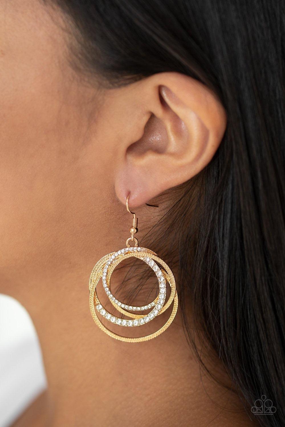 Paparazzi Accessories Elegantly Entangled - Gold Encrusted in sections of white rhinestones, mismatched gold hoops layer into an elegantly entangled lure. Earring attaches to a standard fishhook fitting. Sold as one pair of earrings. Jewelry