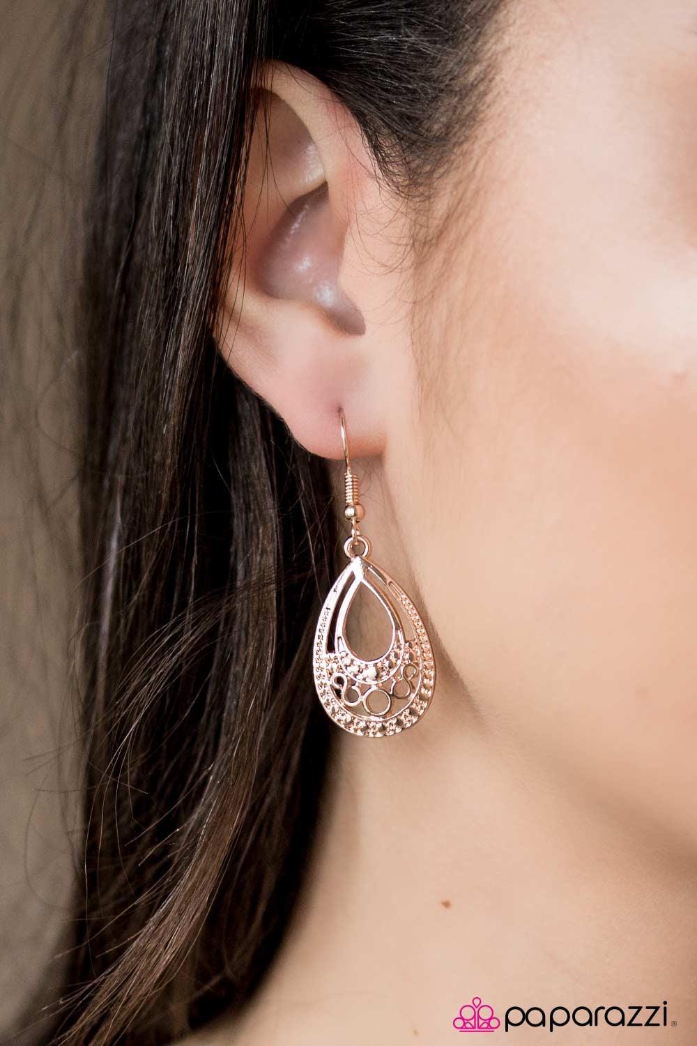 Paparazzi Accessories Desert Rain - Rose Gold Brushed in a glistening finish, rose gold filigree swirls along the bottom of a teardrop frame, adding a frilly pattern to the textured lure. Earring attaches to a standard fishhook fitting. Jewelry