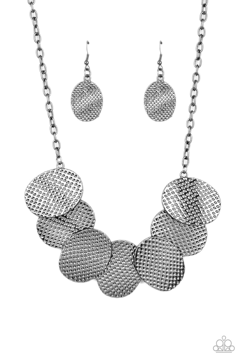 Paparazzi Accessories Industrial Wave - Black A row of gently warped gunmetal discs link together in an overlapping fashion as they connect on each end to a gunmetal chain. Etched in a hammered gunmetal finish, the oval discs create an edgy industrial eff
