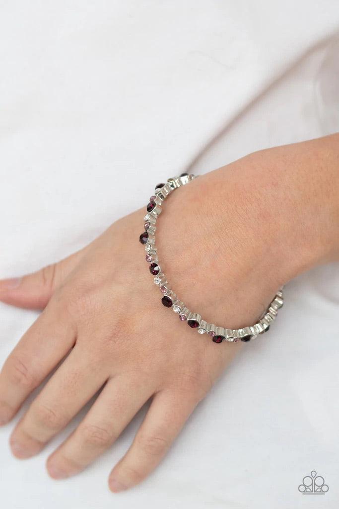 Paparazzi Accessories Twinkly Trendsetter - Purple Encased in sleek silver fittings, a twinkly collection of dark purple, purple, and white rhinestones coalesce into a glittery bangle around the wrist. Sold as one individual bracelet. Bracelets