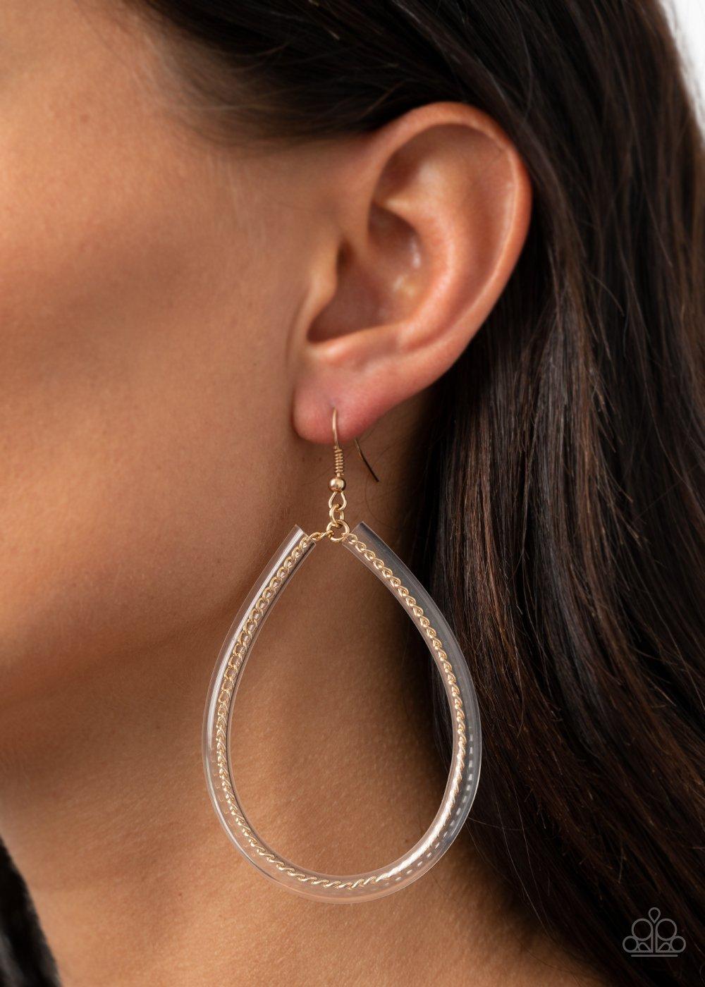 Paparazzi Accessories Just In Case You Missed It - Gold A dainty gold chain-like wire is threaded through the center of an invisible tube, creating an edgy teardrop. Earring attaches to a standard fishhook fitting. Sold as one pair of earrings. Jewelry