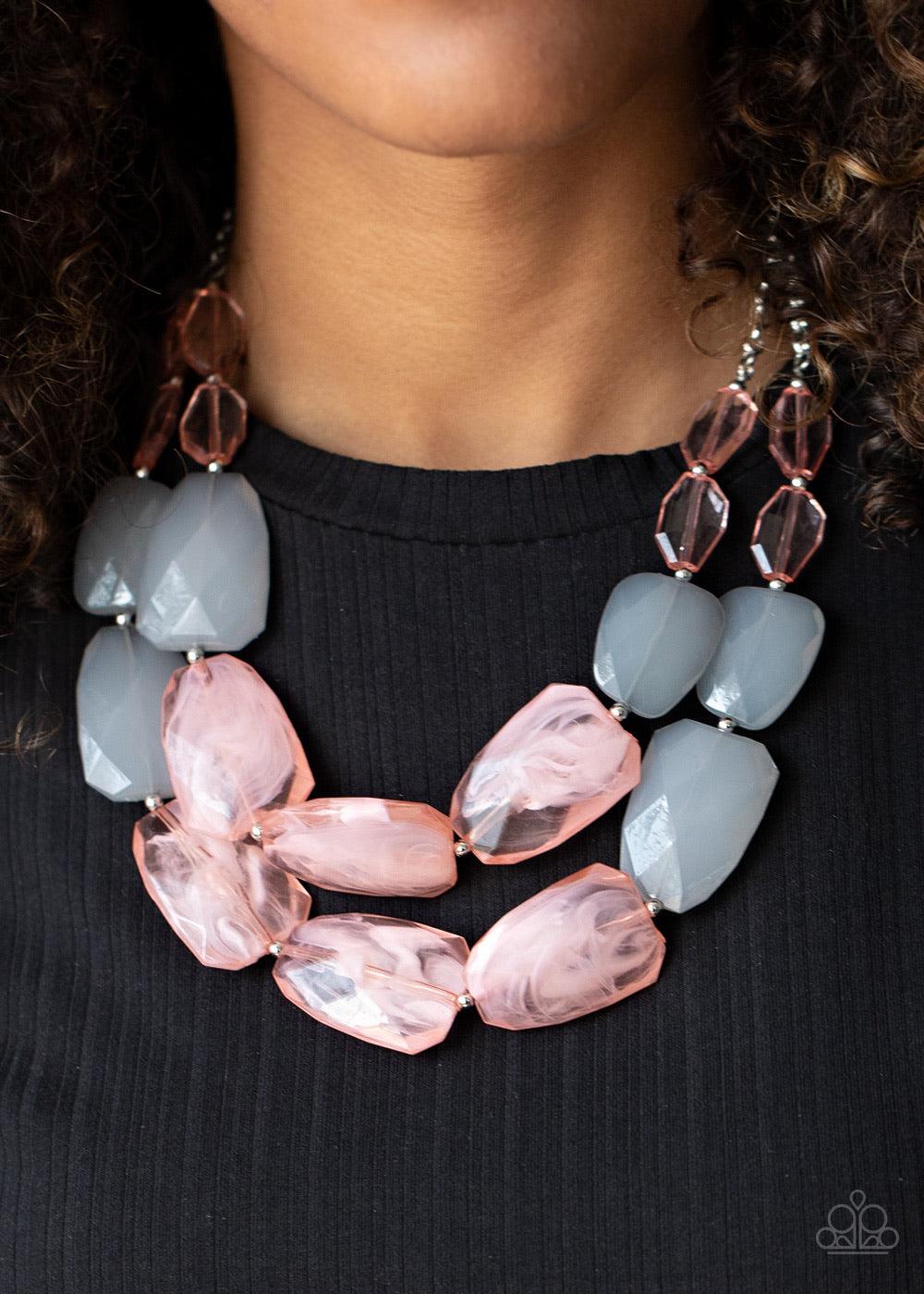 Paparazzi Accessories Gives Me Chills - Pink Varying in shape and size, opaque pink and gray crystal-like beads delicately link into two colorfully icy layers below the collar for a stunning statement-making finish. Features an adjustable clasp closure. S