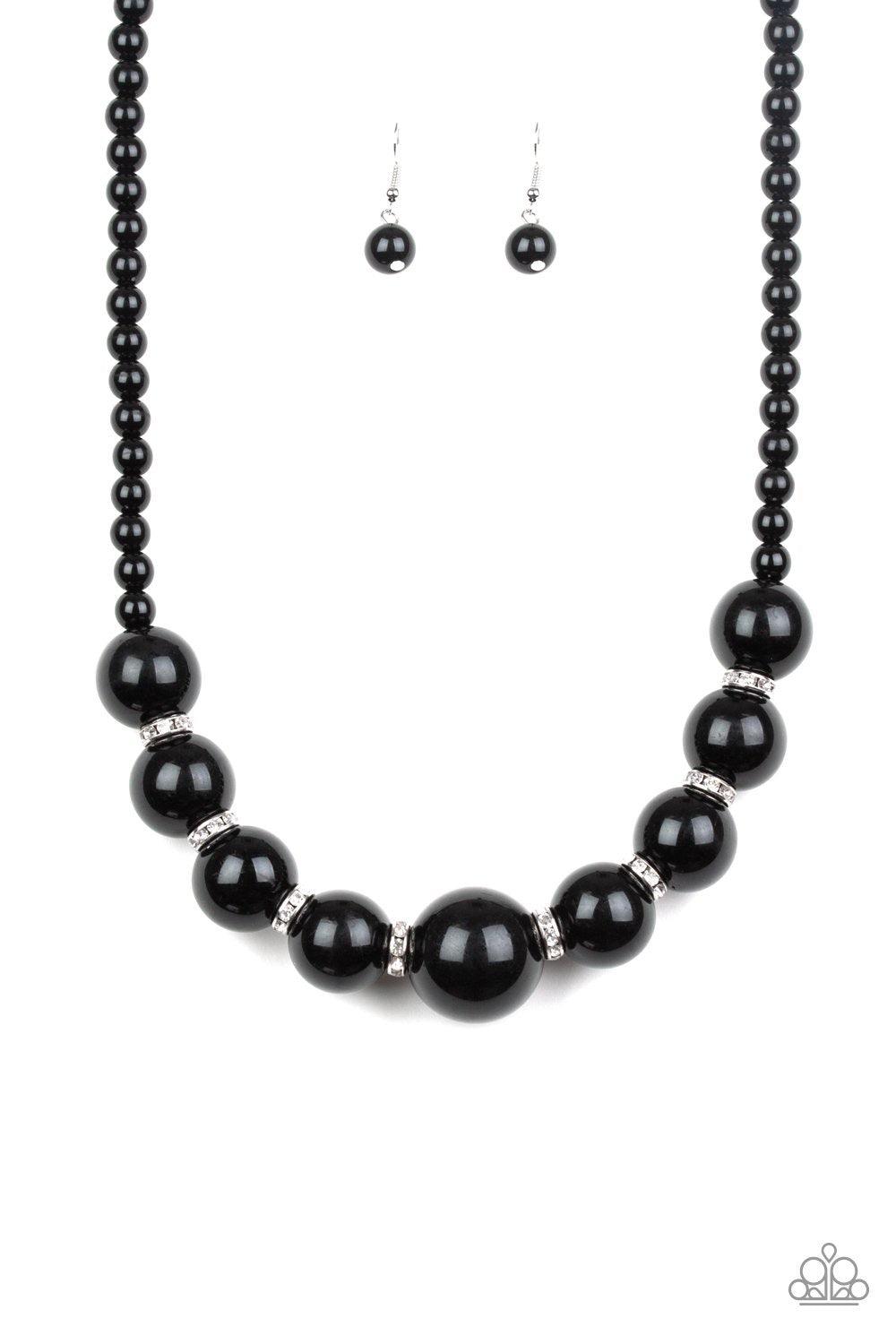 Paparazzi Accessories SoHo Socialite - Black Threaded along an invisible wire, classic black beads give way to an alternating collection of over-sized black beads and white rhinestone encrusted rings below the collar for a timeless sparkle. Features an ad