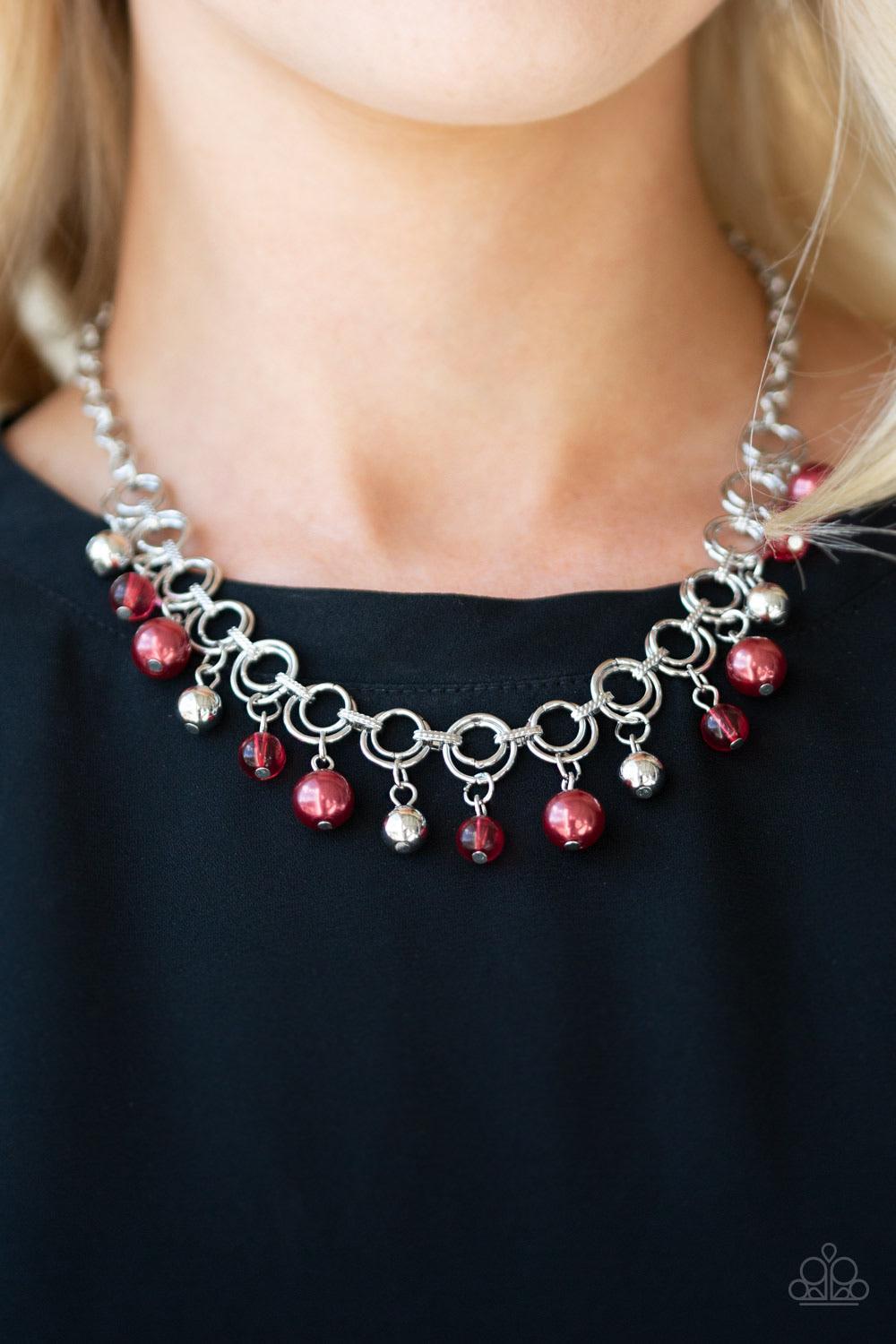 Paparazzi Accessories Fiercely Fancy - Red Featuring pearly and glassy finishes, an array of silver and red beads swing from a double-linked silver chain, creating a fancy fringe below the collar. Features an adjustable clasp closure. Sold as one individu