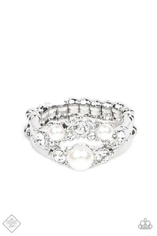 Paparazzi Accessories A-List Ambience - White Featuring pronged silver fittings, a bubbly collection of white pearls and glassy white rhinestones coalesce into two effervescent bands across the finger. Features a dainty stretchy band for a flexible fit. S