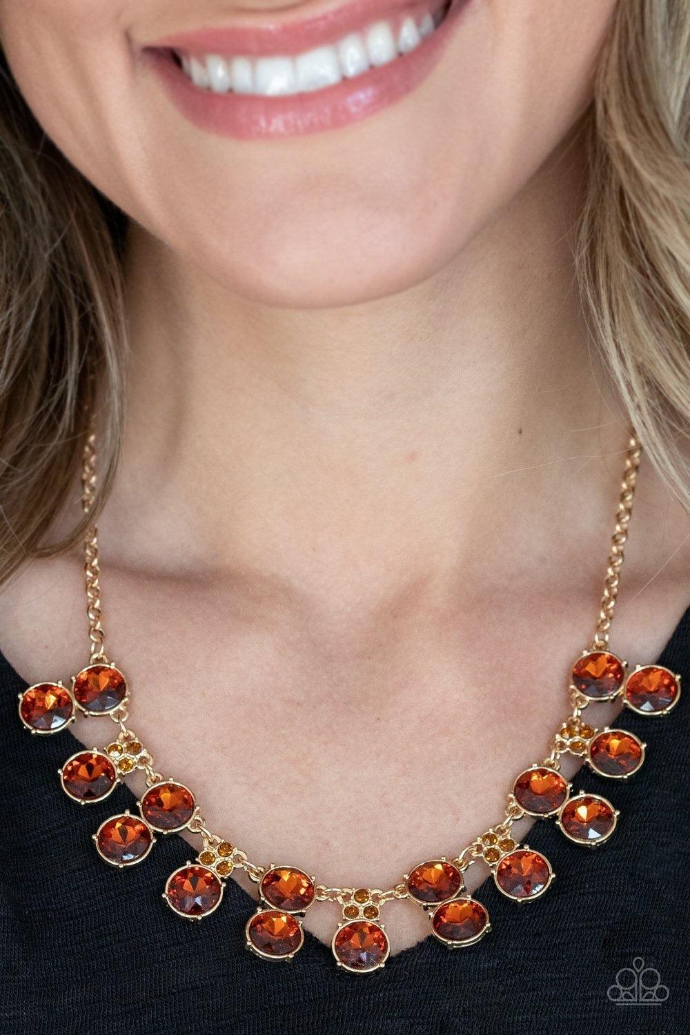 Paparazzi Accessories Top Dollar Twinkle - Brown Pairs of stacked topaz rhinestone frames alternate with solitaire topaz rhinestones crowned in dainty topaz rhinestones along a shiny gold chain, creating a glamorous fringe below the collar. Features an ad