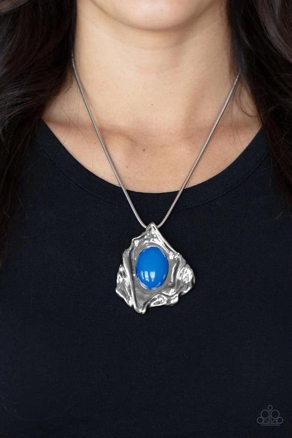Paparazzi Accessories Amazon Amulet - Blue A glassy blue oval bead is pressed into the center of an abstract silver frame below the collar, creating a colorful artisan inspired pendant at the bottom of a rounded silver snake chain. Features an adjustable