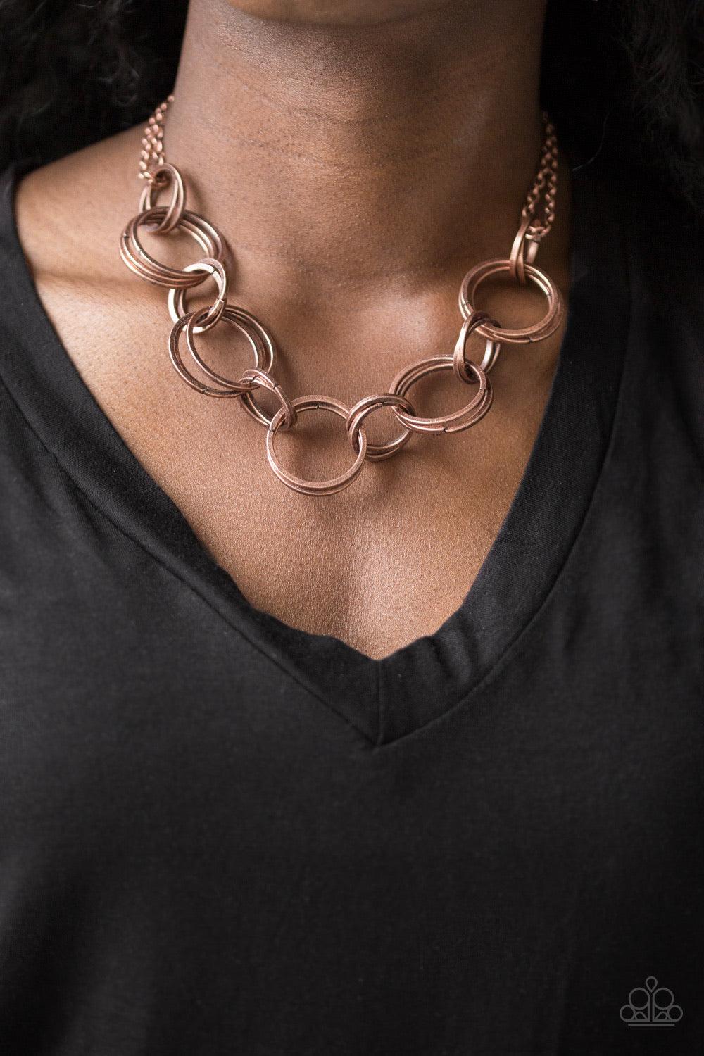 Paparazzi Accessories Jump Into The Ring - Copper Brushed in an antiqued shimmer, doubled and tripled copper hoops link below the collar for a bold industrial look. Features an adjustable clasp closure. Jewelry