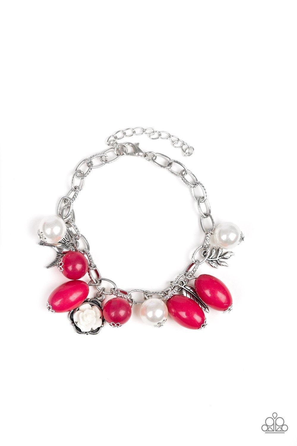 Paparazzi Accessories Love Doves - Pink Gorgeous pearls, shiny pink beading, and a collection of shiny silver charms, including a bird and a feather, dance around the wrist in a whimsical fashion. Features an adjustable clasp closure. Sold as one individu