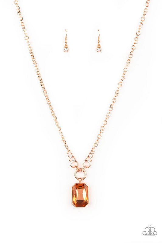 Paparazzi Accessories Queen Bling - Copper Featuring a regal emerald style cut, an oversized gem swings from the bottom of dramatic white rhinestone encrusted shiny copper fittings for a glamorous look. Features an adjustable clasp closure. Sold as one in