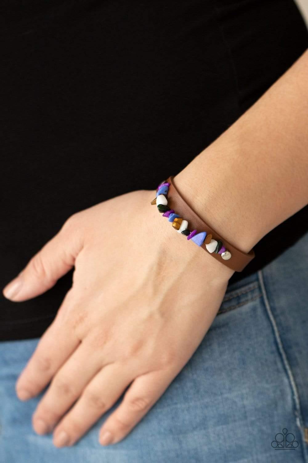 Paparazzi Accessories Pebble Paradise - Multi A strand of multicolored pebbles is studded in place across the front of a skinny brown leather band, creating a colorful earthy display around the wrist. Features an adjustable snap closure. Sold as one indiv