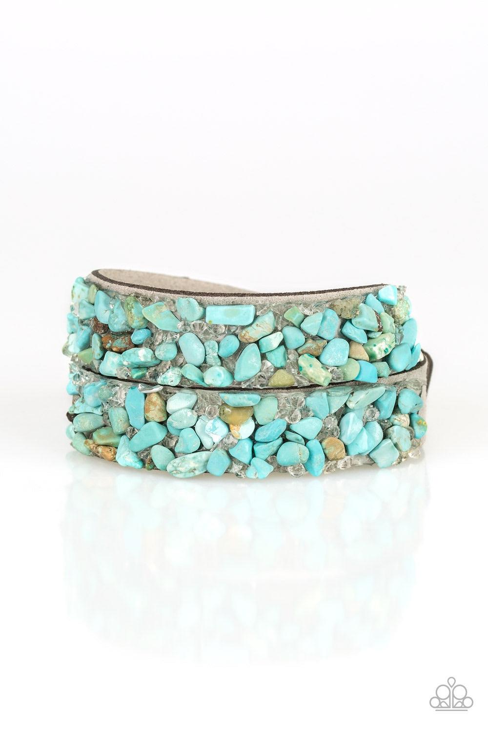 Paparazzi Accessories Crush to Conclusions - Blue A collection of crushed turquoise rocks and glassy white rhinestone prisms are sprinkled across a gray suede band for a seasonal look. The elongated band allows for a trendy double wrap design. Features an