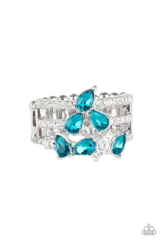 Paparazzi Accessories Blink Back TIERS - Blue Dainty white rhinestones and blue teardrop gems are sprinkled across the center of tiered silver bands encrusted in dazzling white rhinestones. Features a stretchy band for a flexible fit. Sold as one individu