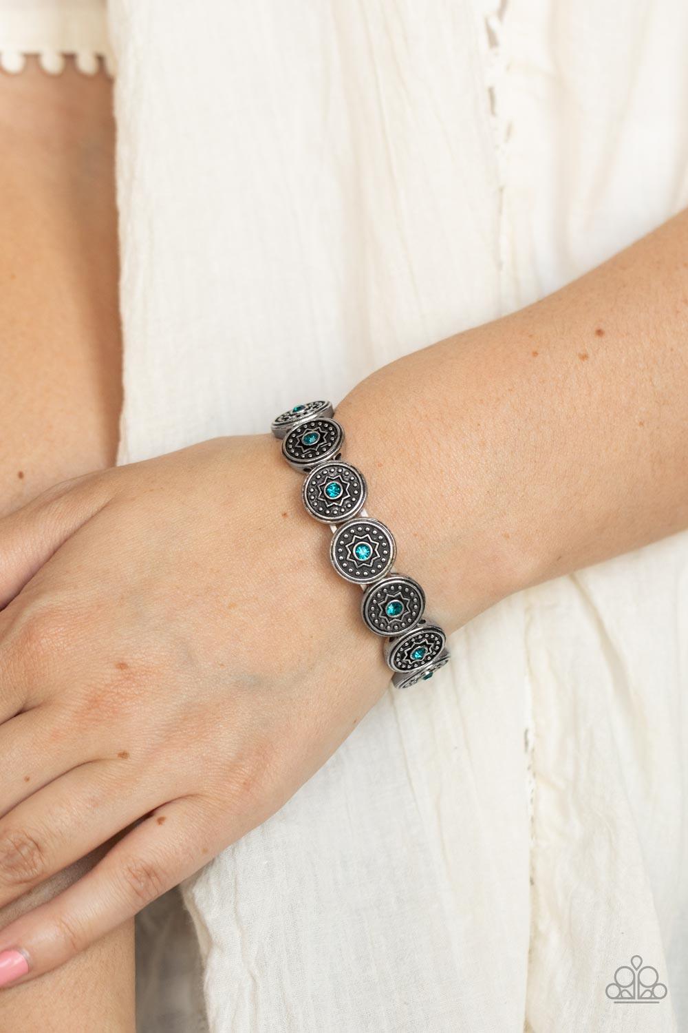 Paparazzi Accessories Colorfully Celestial - Blue Dotted with glittery blue rhinestones, a collection of antiqued studded silver frames are embossed in star accents as they are threaded along stretchy bands around the wrist for a stellar fashion. Sold as