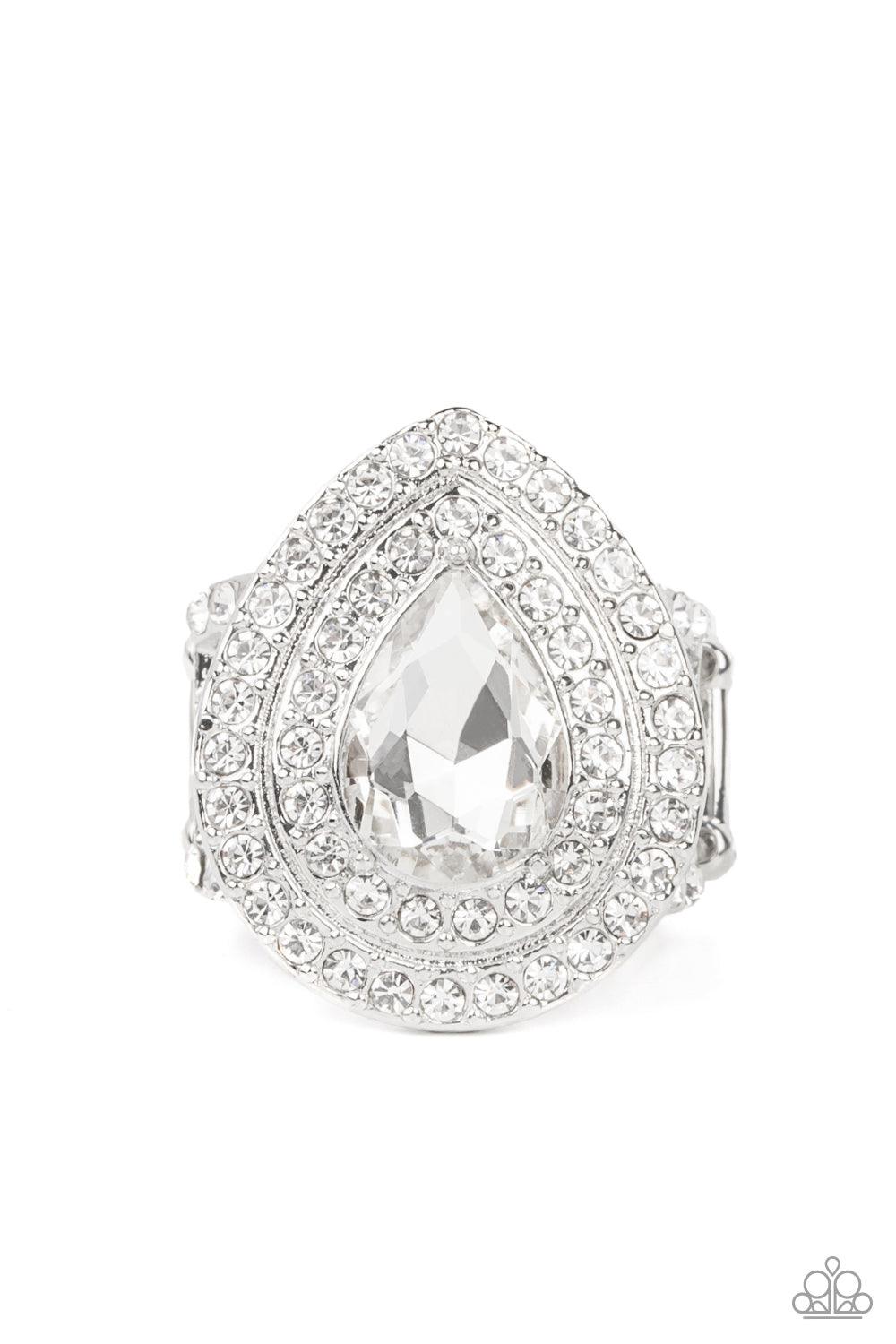 Paparazzi Accessories Icy Indulgence - White A dramatically oversized white teardrop gem twinkles inside two borders of glassy white rhinestones, resulting in a sparkly statement atop the finger. Features a stretchy band for a flexible fit. Sold as one in