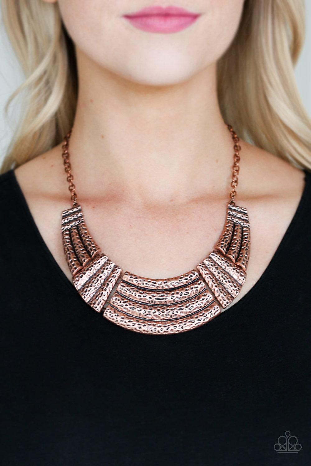 Paparazzi Accessories Ready to Pounce - Copper A collection of hammered copper plates connect into a dramatic half-moon pendant below the collar for a fierce look. Features an adjustable clasp closure. Sold as one individual necklace. Includes one pair of