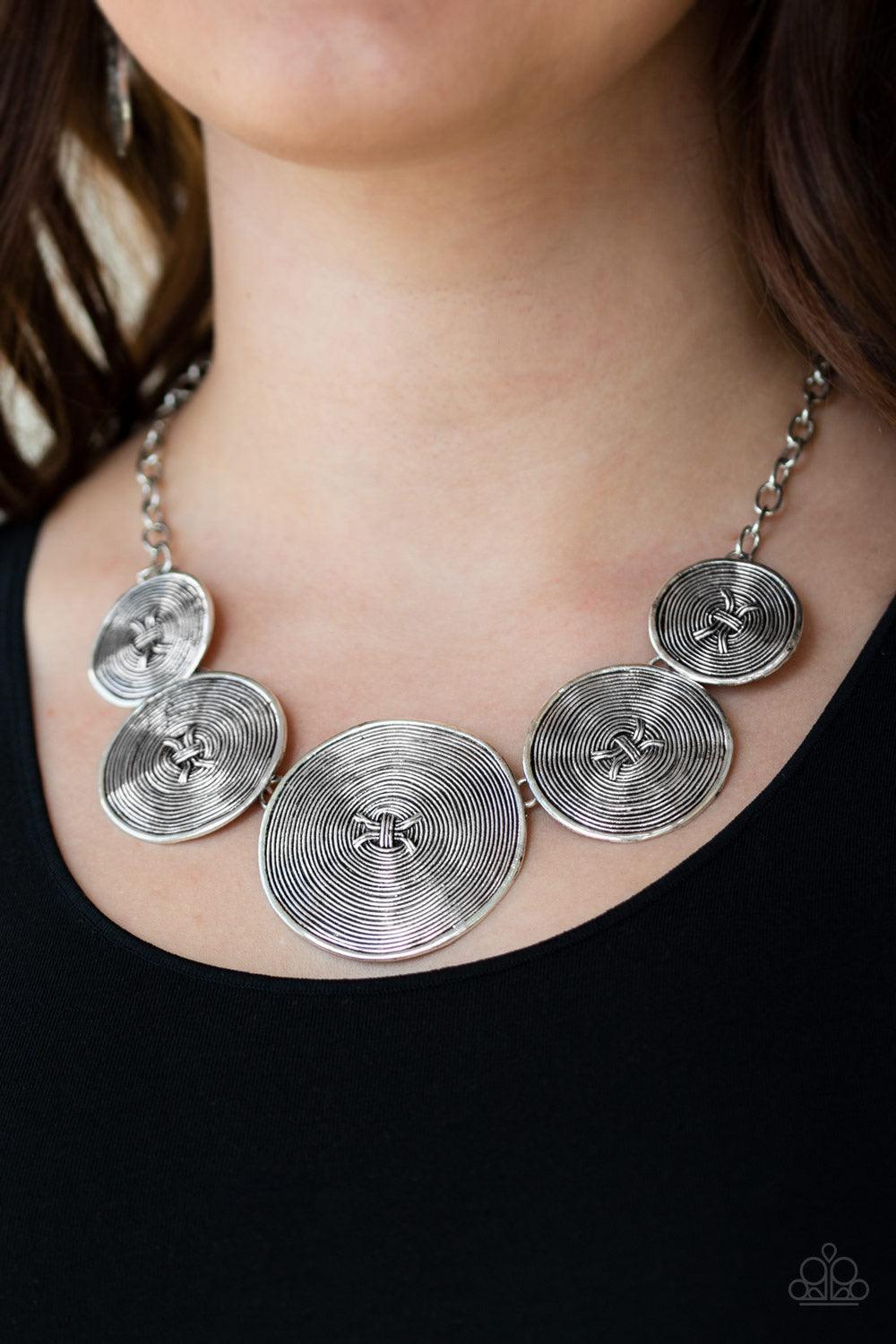 Paparazzi Accessories Deserves A Medal - Silver Radiating with spiraling textures, antiqued silver discs gradually increase in size as they link below the collar for a statement making look. Features an adjustable clasp closure. Jewelry