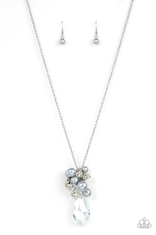 Paparazzi Accessories Drip Drop Dazzle - Silver Featuring an iridescent shimmer, a dramatically oversized crystal-like teardrop swings from the bottom of a cluster of shiny silver, pearly silver, and crystal-like beads, creating a dazzling pendant at the