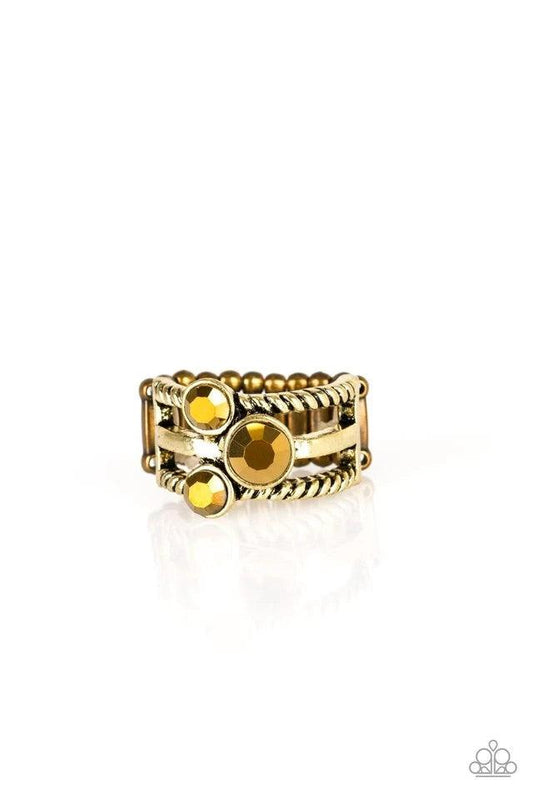 Paparazzi Accessories Head In The Stars - Brass A trio of glittery aurum rhinestones are sprinkled along smooth and twisted brass bands, creating edgy layers across the finger. Features a stretchy band for a flexible fit. Jewelry