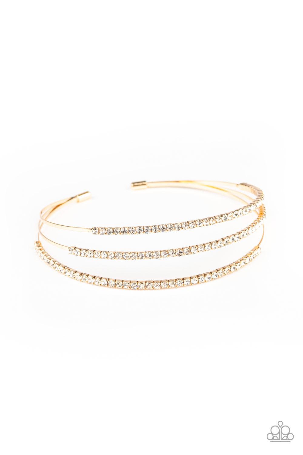 Paparazzi Accessories Iridescently Infatuated - Gold Sections of glittery white rhinestones are encrusted along the tops of three dainty gold bars that coalesce into a glitzy cuff around the wrist. Jewelry