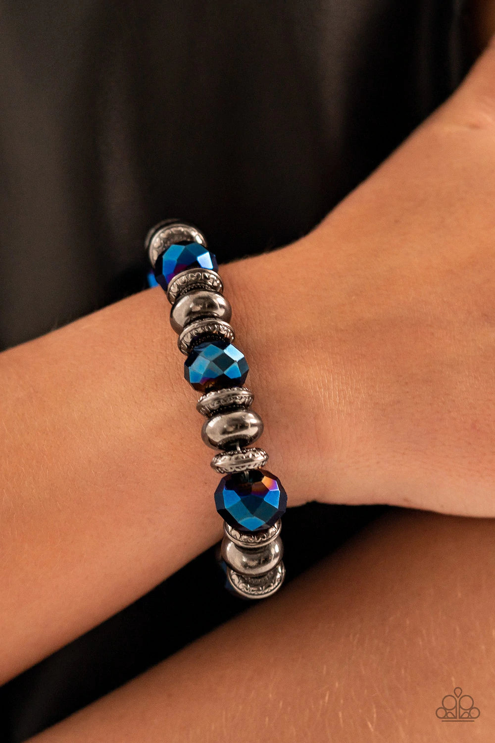 Paparazzi Accessories Power Pose - Blue An oversized assortment of textured gunmetal rings, smooth gunmetal beads, and metallic blue crystal-like beads are threaded along stretchy bands around the wrist for a glitzy finish. Sold as one individual bracelet