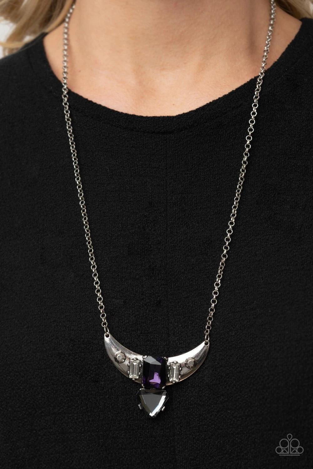 Paparazzi Accessories You the TALISMAN! - Purple Pairs of faceted silver beads and glassy white emerald cut gems flank an oversized emerald cut purple gem atop an antiqued silver half moon frame. A smoky triangular cut gem adorns the bottom of the pendant
