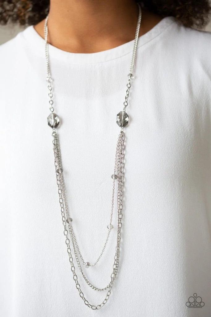 Paparazzi Accessories Dare To Dazzle - Silver Infused with metallic crystal-like beads, a pair of glittery metallic gems gives way to layers of mismatched silver chains for a dazzling look. Features an adjustable clasp closure. Sold as one individual neck
