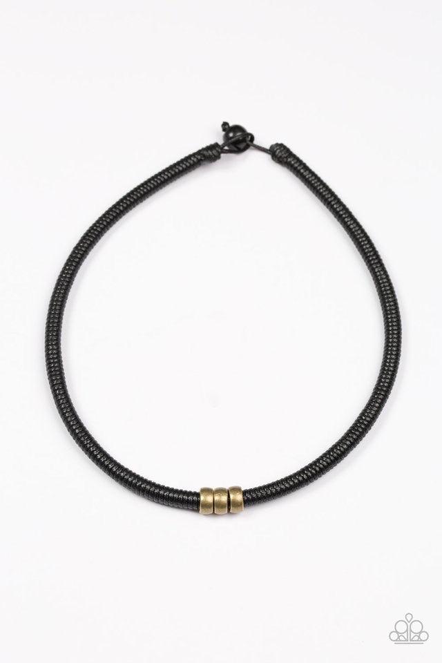 Paparazzi Accessories Trail Rules - Brass Shiny black twine wraps around a black cord, creating an urban look below the collar. Shiny brass beads slide along the cording for a rugged finish. Features a button loop closure. Sold as one individual necklace.