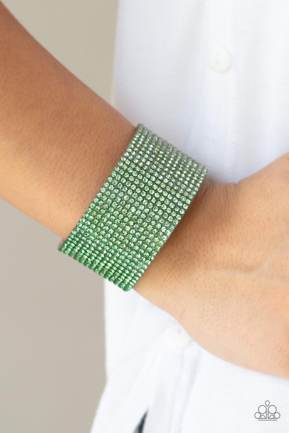Paparazzi Accessories Fade Out - Green Row after row of glassy rhinestones gradually fade from light green to dark green across the front of a thick gray suede band for a trendy ombre look. Features an adjustable snap closure. Jewelry