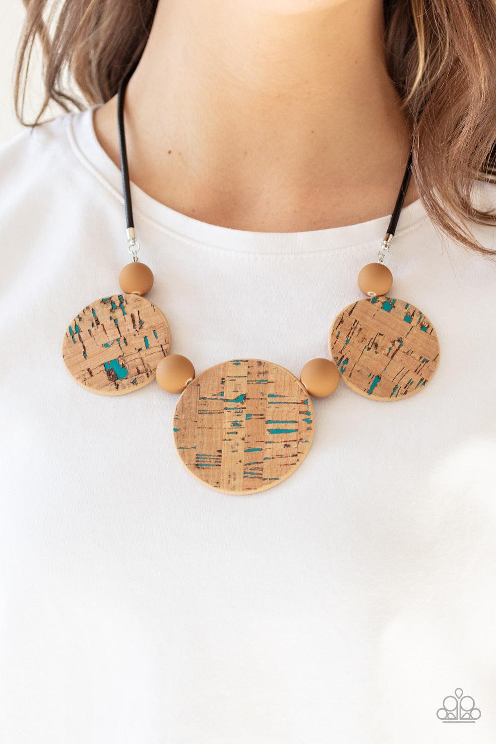 Paparazzi Accessories Pop The Cork - Blue Featuring blue accents, cork-like frames and brown matte beads are threaded along an invisible wire below the collar for a statement-making look. Features an adjustable clasp closure. Sold as one individual neckla