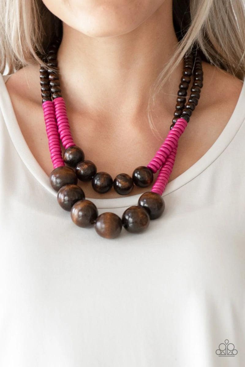 Paparazzi Accessories Cancun Cast Away - Pink Earthy brown and vivacious pink wooden beads and discs are threaded along shiny strands of brown cording, creating colorful layers. Features a button loop closure. Sold as one individual necklace. Includes one